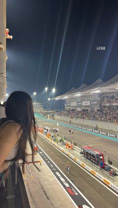 a woman looking out the window at a race track