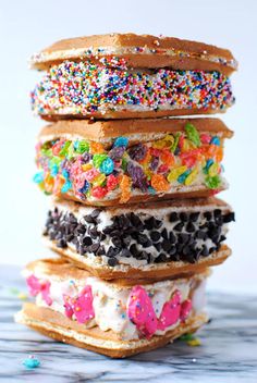 a stack of doughnuts with sprinkles and toppings on them