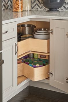 an open cabinet in the corner of a kitchen