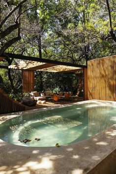 an outdoor swimming pool surrounded by trees