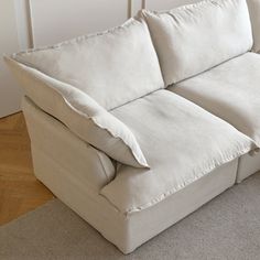 a white couch sitting on top of a wooden floor