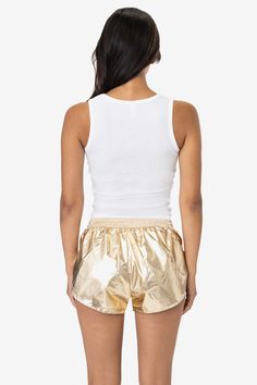 A metallic foil version of our nylon taffeta short. This nostalgic throwback style is light, breezy, sexy and fun. Minimalistic coverage makes this short perfect for lounging around at home, as a swimsuit coverup, or layered on top of your favorite training shorts for running. This style features an internal, brief liner of cotton jersey or nylon mesh and may vary depending on color. • Women's • Made in Los Angeles, Calif.• Lightweight Foil Coated Nylon• Elastic Waistband• 100% Nylon | Metallic Women's Running Shorts, Woman In Gold, Running Shorts Women, Training Shorts, Metallic Foil, Running Shorts, Running Women, Foil, Cover Up