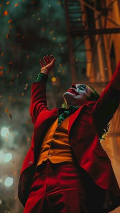 a man dressed as the joker waves to people