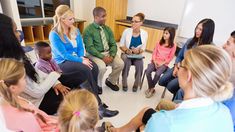 a group of people sitting in a circle talking