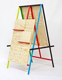 an easel made out of plywood and wood with different colored sections on each side