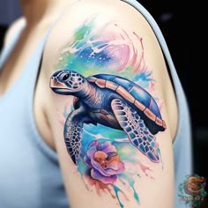 a woman's arm with a turtle and flowers tattoo on the left side of her body