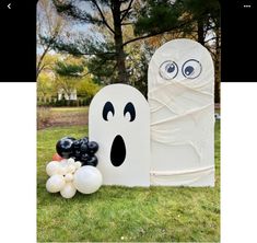 a fake ghost and balloons in the grass