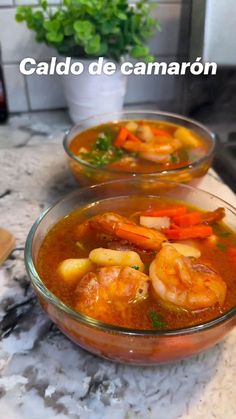 two bowls filled with soup sitting on top of a counter