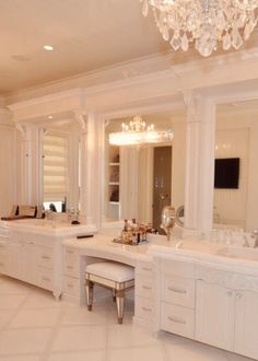 a large bathroom with two sinks and a chandelier