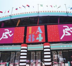 the entrance to an amusement park with banners on it