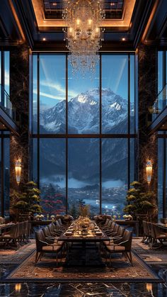 a dining room with large windows and a view of the snow covered mountains in the distance