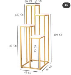 three gold metal stands with white marble tops and measurements for each one, including the height