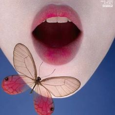 a woman's lips with two butterflies sticking out of her mouth and one on the lip