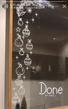 a glass window with christmas ornaments drawn on it and the words done written in white