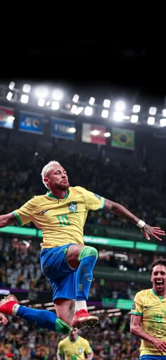 a man jumping in the air while wearing blue and yellow soccer uniforms at a game