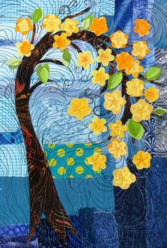 a quilted tree with yellow flowers on it's branches and blue sky in the background