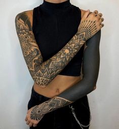 a woman with tattoos on her arms and arm