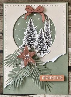 a handmade christmas card with pine trees and poinsettis