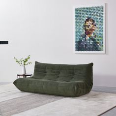 a living room filled with furniture and a painting on the wall