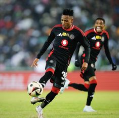 two men are playing soccer on the field