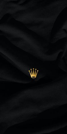 a black fabric with a gold crown on the front and back side, it is very dark