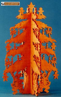 an intricately carved wooden christmas tree on a blue background