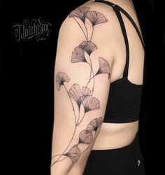 a woman's arm with flowers on it and the back of her body is shown