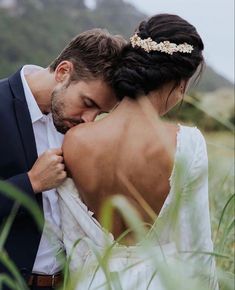 the bride and groom are embracing each other