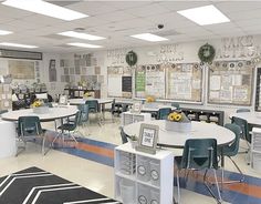 an empty classroom with desks, chairs and bulletin boards on the wall behind them