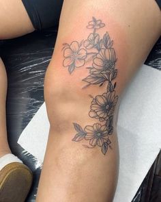 a woman's leg with flowers on it