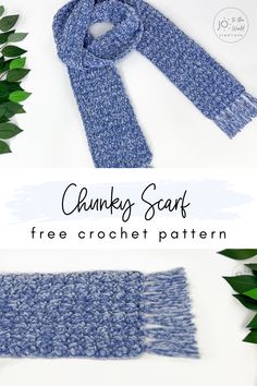 the chunky scarf is knitted in blue yarn and sits next to some green leaves