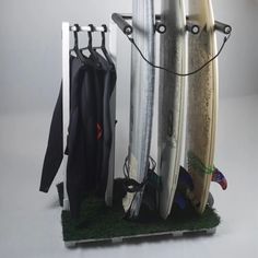 three surfboards are hanging on a rack