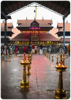 there are many gold candles in front of the building