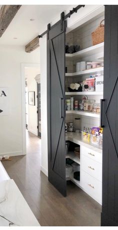 an open pantry with sliding doors and shelves