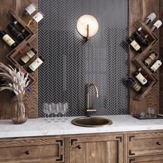 a kitchen counter with a sink and wine rack on the wall above it, along with several bottles of wine