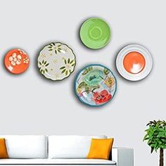 a living room filled with furniture and plates on the wall