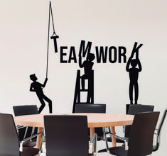 the silhouettes of two people are on top of a sign that says teamwork