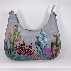 Gorgeous! Anuschka Hand Painted Leather Hobo Style Shoulder Bag With Southwest Garden Art Work. Anuschka Means "Like No Other" And Each Bag Is Truly A One-Of-A-Kind Wearable Work Of Art. You Will Receive Compliment After Compliment When You Carry This Bag. Details: Hand Painted Original Artwork By Master Artisans. Beautiful Embroidered Accents (See Photos). Size/Profile: Hobo Walls - Top Grain Hand-Painted Leather; Signature Logo; Embroidered Finish. Handles/Strap - Attached Shoulder Strap With Leather Purse Diy, Southwest Garden, Painted Leather Purse, Hand Painted Leather Bag, Painted Leather Bag, Painted Gifts, Hand Painted Purses, Flamingo Bag, Painted Purse