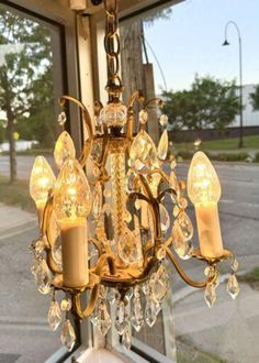 a chandelier hanging in front of a window