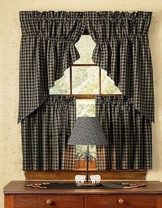 an image of a window with black and white checkered curtains