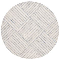 a round rug with white and blue stripes on the bottom, in front of a white background