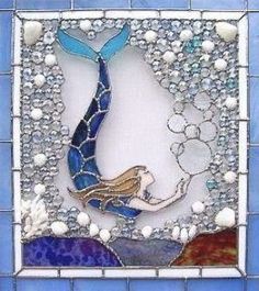 a blue and white mosaic tile with a mermaid on it