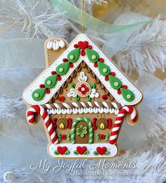 a christmas ornament hanging from a tree with candy canes and decorations on it