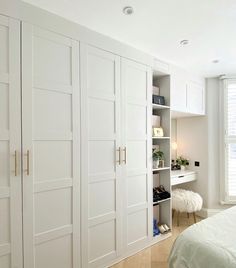 an instagram photo of a bedroom with white closets