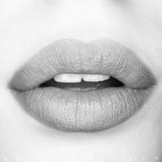 a woman's lips are shown in black and white