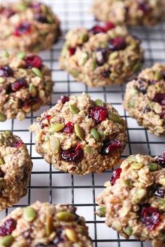 several cookies with cranberries and nuts on a cooling rack, ready to be eaten