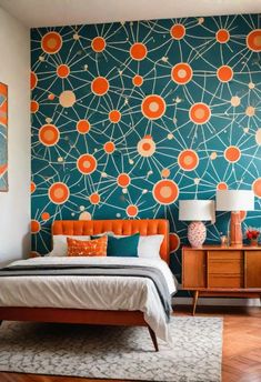 a bedroom with a bed, dresser and wallpaper in orange and teal colors