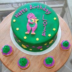 a birthday cake with purple and green frosting