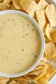 a bowl of dip surrounded by tortilla chips