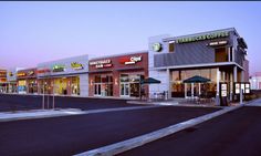 the outside of a starbucks coffee shop at dusk